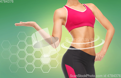 Image of close up of slim fit woman's body with trained abs