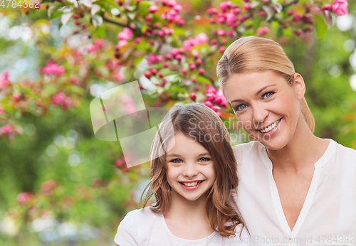 Image of happy mother and daughter over garden