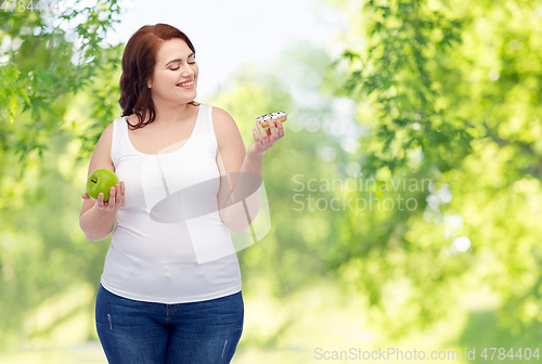 Image of plus size woman choosing between apple and donut