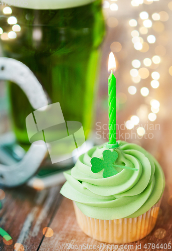 Image of green cupcake with candle, beer and horseshoe