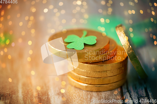 Image of gold coins with shamrock on wooden table