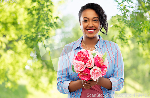 Image of happy african american woman with bunch of flowers