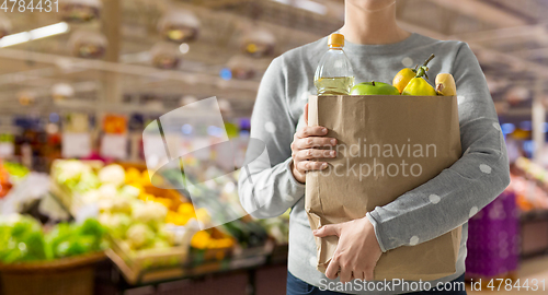 Image of close up of woman with paper bag full of food
