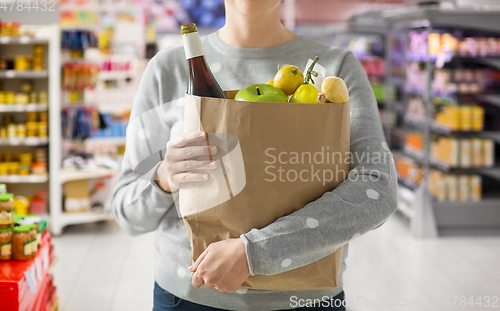 Image of close up of woman with paper bag full of food