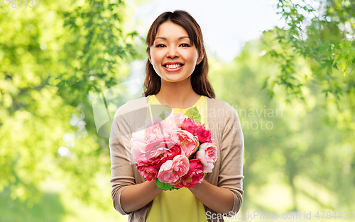 Image of happy asian woman with bunch of flowers