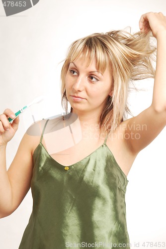 Image of A young woman with a toothbrush