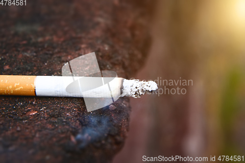 Image of smoking cigarette side view