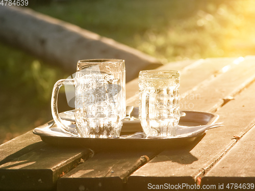 Image of Glass jugs empty in the sunset