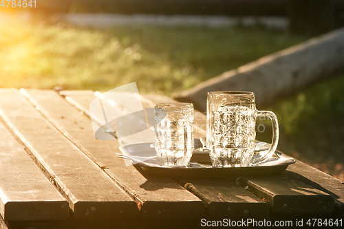 Image of Glass jugs empty in the sunset