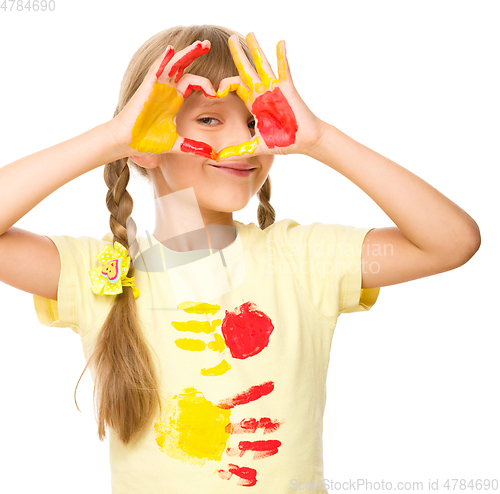 Image of Portrait of a cute girl playing with paints