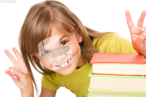 Image of Little girl with a pile of books