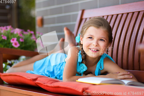 Image of Little girl is reading a book