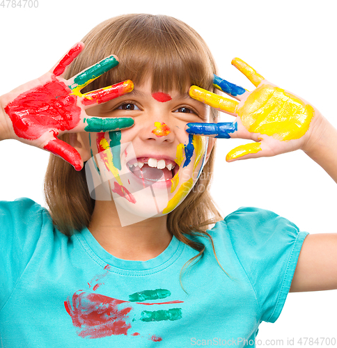 Image of Portrait of a cute girl playing with paints