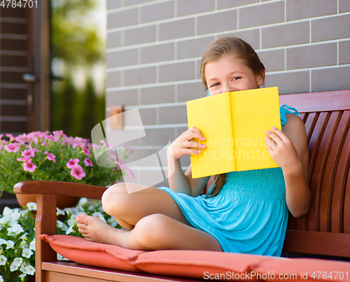 Image of Little girl is reading a book