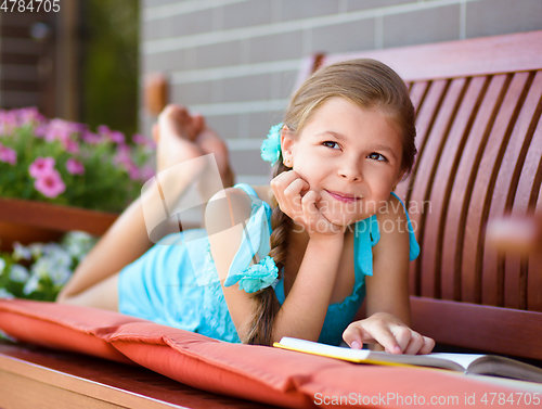 Image of Little girl is reading a book