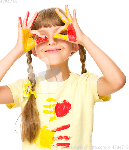 Image of Portrait of a cute girl playing with paints