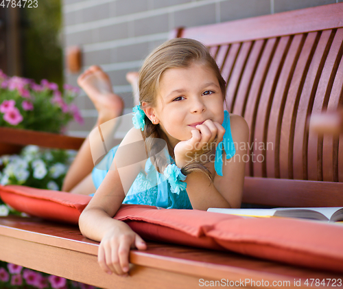 Image of Little girl is reading a book