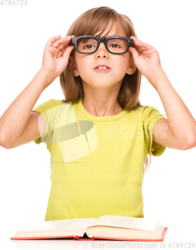 Image of Little girl is reading a book