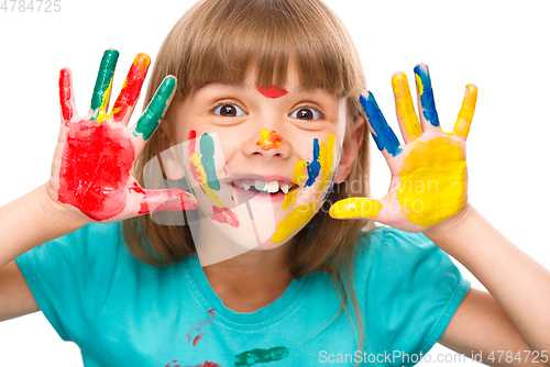 Image of Portrait of a cute girl playing with paints