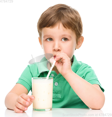 Image of Cute little boy with a glass of milk