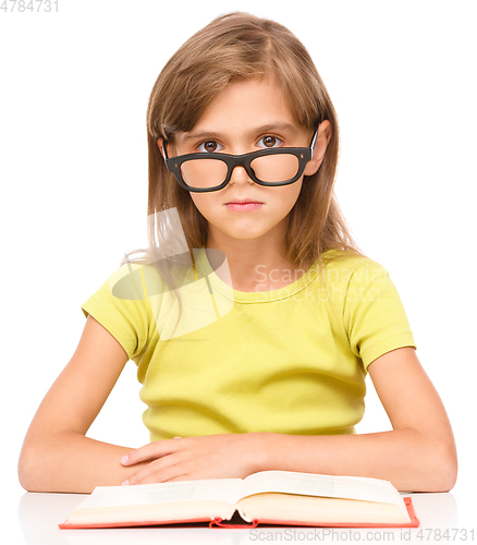 Image of Little girl is reading a book