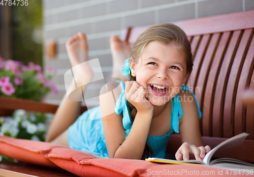 Image of Little girl is reading a book