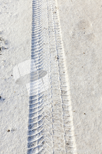 Image of fingerprint from the car tires on snow close-up