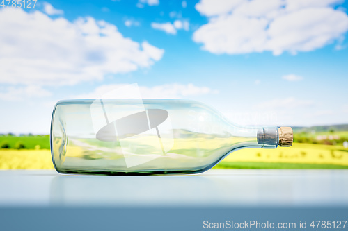 Image of lying glass bottle landscape scenery background