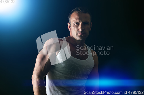 Image of handsome muscle man blue light