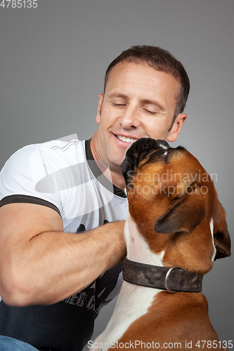 Image of handsome muscle man with his dog