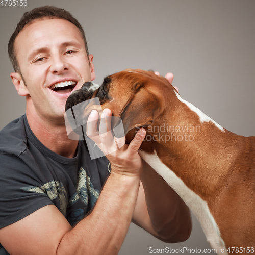Image of handsome laughing man with his dog
