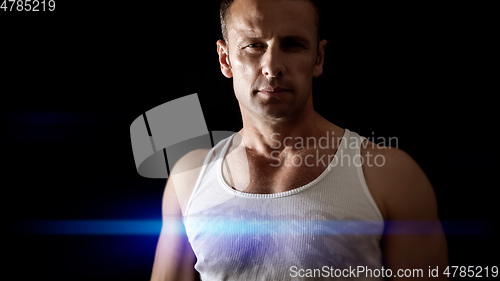 Image of handsome muscle man blue light