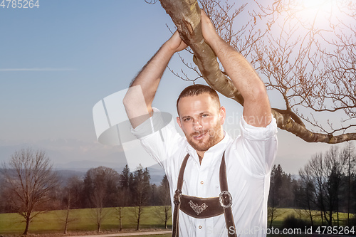 Image of bavarian tradition man in the grass