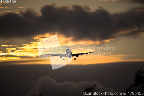 Image of air plane in sunset sky