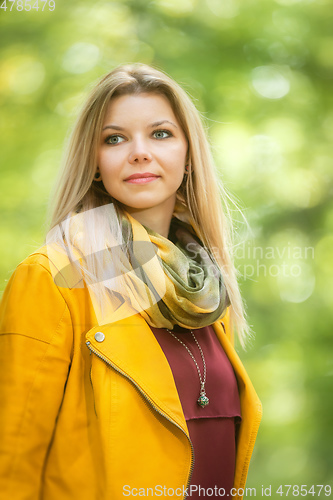 Image of beautiful young woman portrait autumn outdoor