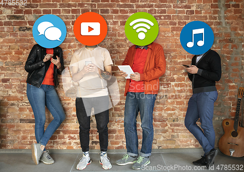 Image of Creative millenial people connecting and sharing social media. Modern UI icons as heads