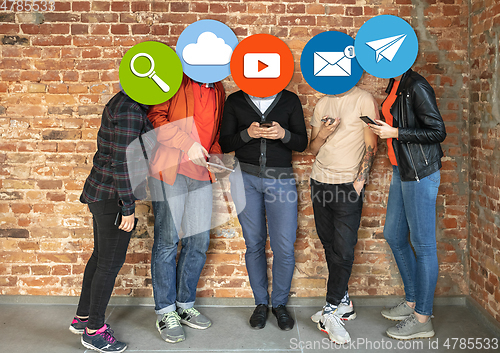 Image of Creative millenial people connecting and sharing social media. Modern UI icons as heads