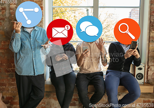 Image of Creative millenial people connecting and sharing social media. Modern UI icons as heads