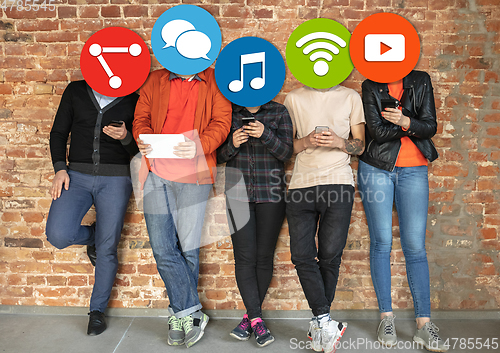 Image of Creative millenial people connecting and sharing social media. Modern UI icons as heads