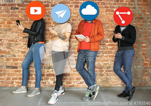 Image of Creative millenial people connecting and sharing social media. Modern UI icons as heads