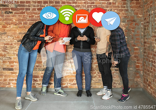 Image of Creative millenial people connecting and sharing social media. Modern UI icons as heads