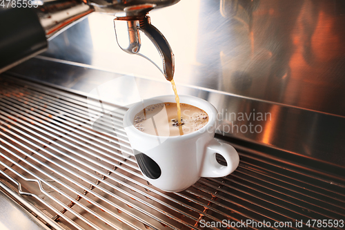 Image of Stylish black espresso making machine brewing two cups of coffee, shooted in cafe.