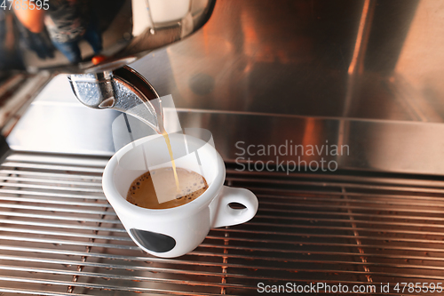 Image of Stylish black espresso making machine brewing two cups of coffee, shooted in cafe.