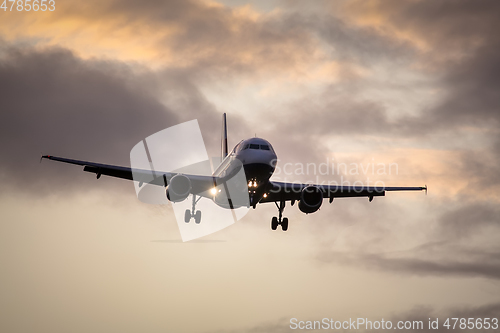 Image of air plane in sunset sky