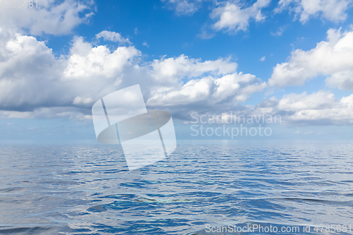 Image of blue sky with white clouds over the sea