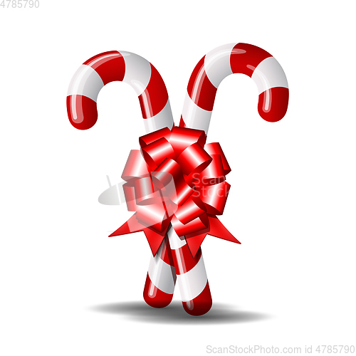 Image of Christmas candy cane with red bow isolated on white