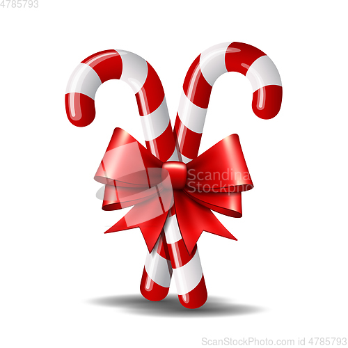 Image of Christmas candy cane with red bow isolated on white