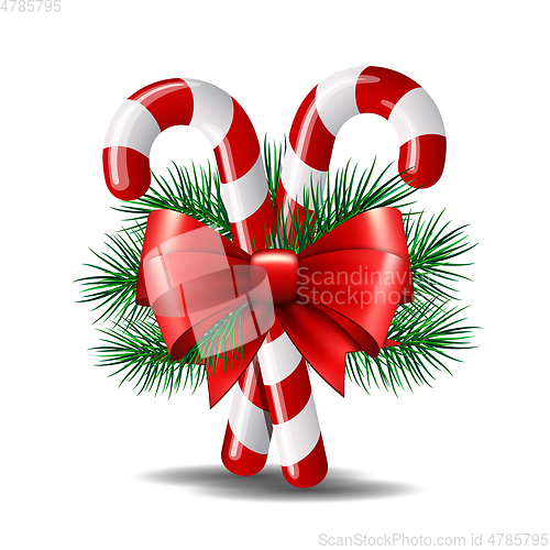 Image of Christmas candy canes with red bow isolated on white.