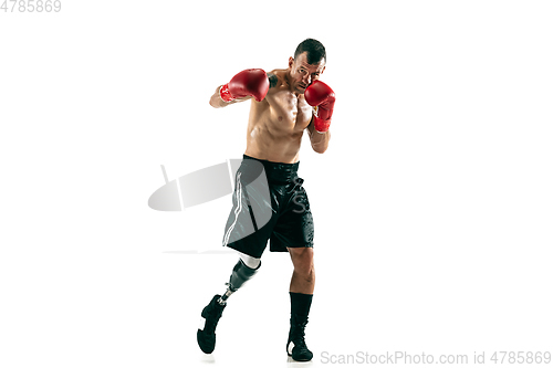 Image of Full length portrait of muscular sportsman with prosthetic leg, copy space. Male boxer in red gloves.