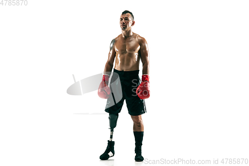 Image of Full length portrait of muscular sportsman with prosthetic leg, copy space. Male boxer in red gloves.